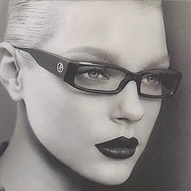 Woman in sculpted black frames with logo temples