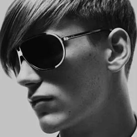 Man in dark metal-rim sunglasses